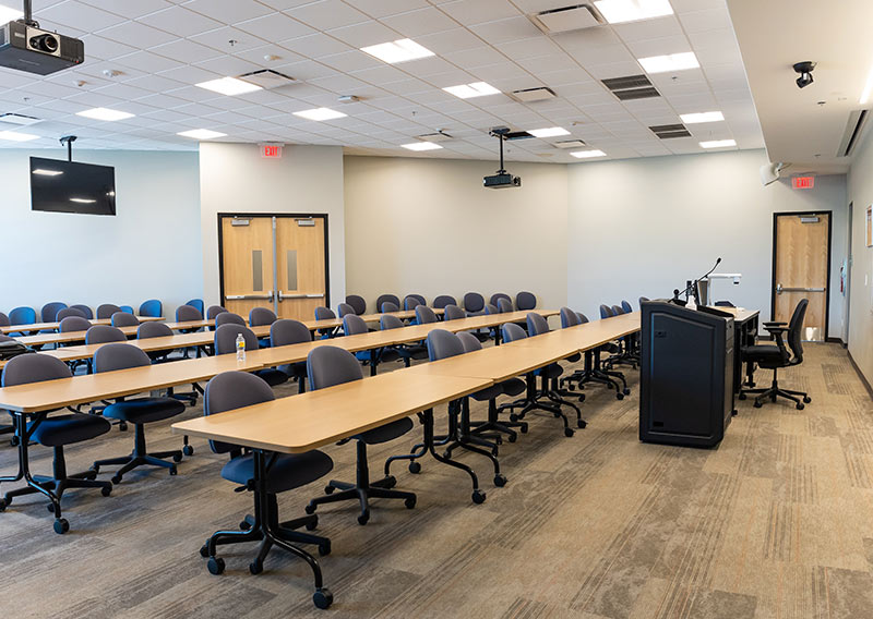 Large Sedona Center classroom arranged with rows of tables and chairs