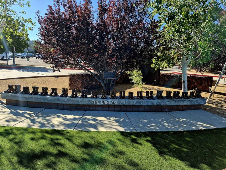 Wide view of The Unheard 22 memorial and its surrounding lawn.