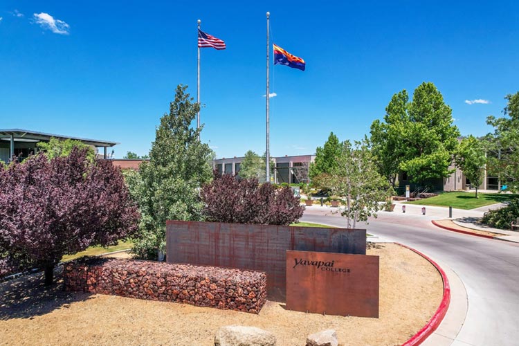 Campus flagpoles and landscaped gathering area.