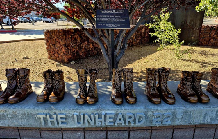 Front view of memorial boots and The Unheard 22 inscription.